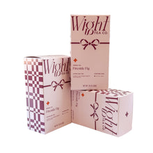 Load image into Gallery viewer, Fireside Fig holiday tea boxes, one box is stacked standing vertically on another box laying on it's side, next to another box standing vertically.
