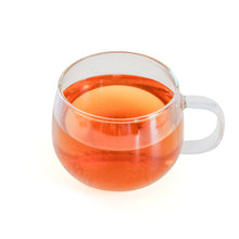 Load image into Gallery viewer, Cup of brewed Fireside Fig herbal tea with a caramel brown color
